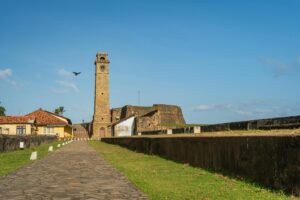 Scenic view of Galle Clock Tower in Sri Lanka, highlighting historic architecture under clear blue skies.