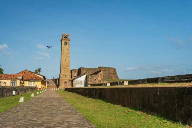 Scenic view of Galle Clock Tower in Sri Lanka, highlighting historic architecture under clear blue skies.